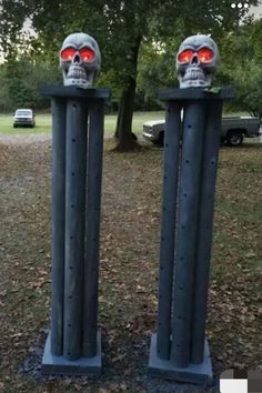 two metal sculptures with red eyes and skulls on them