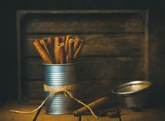 an old tin can with cinnamon sticks in it