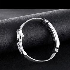 The Mens Stainless Steel Bracelet showcases a minimalist style that is quite on trend. The features include an adjustable mesh band with buckle clasp so that the bracelet can be easily adjusted to fit most men's wrist. The bracelet band width is 12mm, roughly 0.46 inches and the length can accommodate wrist from 6.5 to 8.5 inches. It is a fashionable mens bracelet that can work for all occasions, and can be gifted to teens, young men and older. This stainless steel bracelet is packaged with a je Adjustable Minimalist Stainless Steel Bracelets, Adjustable Silver Stainless Steel Cuff Bracelet, Adjustable Silver Stainless Steel Wristband, Adjustable Stainless Steel Wristband With Bracelet Strap, Silver Metal Bracelet With Black Band, Silver Metal Bracelets With Black Band, Adjustable Stainless Steel Bracelet With Clasp, Adjustable Metal Wristband In Modern Style, Trendy Silver Band Bracelet