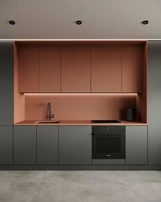 a kitchen with an oven, sink and cupboards on the wall next to it