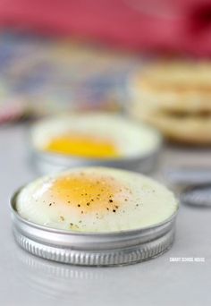 an egg in a tin sitting on top of a table next to other food items