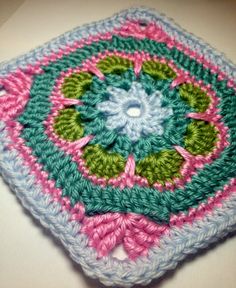 a crocheted square is sitting on a table