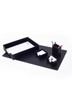 a black desk set with pen, mouse and paper holder on top of the table