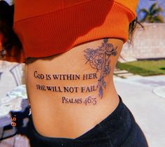 a woman with a cross tattoo on her stomach saying god is within her she will not fail