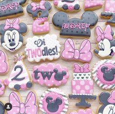 minnie mouse cookies are decorated with pink and gray icing for the first birthday girl