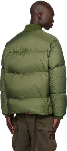 Down-filled quilted nylon satin bomber jacket. · Rib knit stand collar and cuffs · Two-way zip closure · Welt pockets · Felted logo patch at sleeve · Zip pocket at interior · Fully lined · Logo-engraved silver-tone hardware Supplier color: Light bronze green Fill: 90% down, 10% feather. Down Jackets, Winter Green Outerwear With Zip Cuffs, Duck Down Outerwear With Ribbed Cuffs For Outdoor, Silver Engraving, Collar And Cuff, Stand Collar, Welt Pocket, Down Jacket, Patch Logo