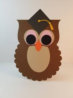 an owl with a graduation cap on it's head