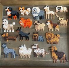 an assortment of cross stitch animals displayed in a box