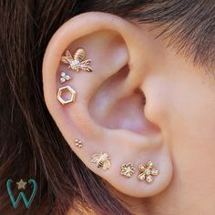 the ear is adorned with gold bee and honeycombs