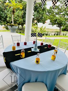 a table set up for a race themed party with drinks and liquor bottles on it