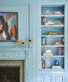 a living room filled with furniture and a fire place in front of a painting on the wall