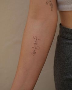 a woman's arm with the word love written in cursive writing