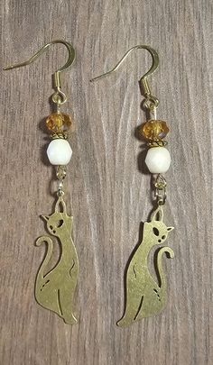 Beaded earrings with brass cat charm. Gold Metal Cat Design Earrings, Gold Metal Earrings With Cat Design, Cat Charm, Cat Earrings, Beaded Earrings, Jewelry Earrings Dangle, Etsy Earrings, Dangle Drop Earrings, Dangle Earrings