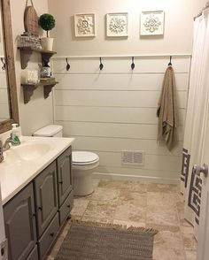 a bathroom with a sink, toilet and shower in it's center piece is shown