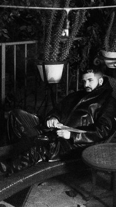 black and white photograph of a man sitting on a bench