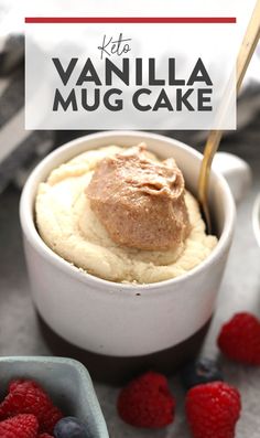 a close up of a mug cake in a bowl with raspberries on the side