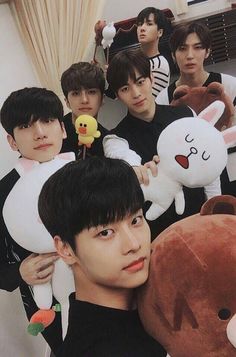 group of young men holding stuffed animals in front of them