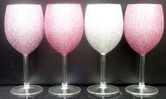 three wine glasses with pink and white glitter on them