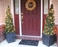 two planters with christmas trees on the front porch