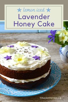 a lemon iced lavender honey cake on a blue and white plate with flowers in the background