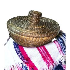 a woven basket sitting on top of a blanket