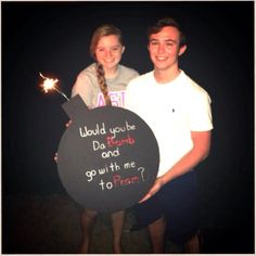 two people standing next to each other holding a sign that says, would you be daunt and go with me too?