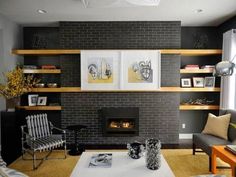 a living room filled with furniture and a fire place next to a wall mounted tv