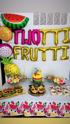 a table topped with lots of food next to a sign that says limoo frutti