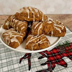 a white plate topped with cookies covered in icing on top of a tablecloth