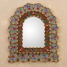 a decorative mirror mounted to the side of a wall