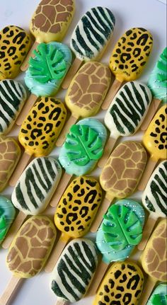 the cookies are decorated with animal print and green icing, along with zebra prints