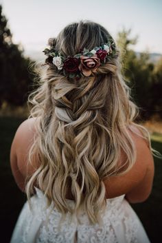 a woman with long blonde hair and flowers in her hair, wearing a flower crown