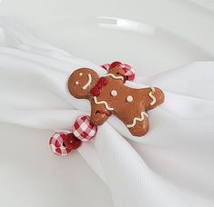 a close up of a napkin with a gingerbread cookie on it's side