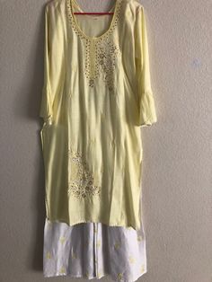 A nice lemon embroidered cotton kurti with white plaajo! Size 38-44 Length: 42' Arm length: 16 Plaajo length: 39' Cotton Long Sleeve Palazzo Set With Gota Work, Cotton Palazzo Set With Gota Work And Long Sleeves, Long Sleeve Cotton Palazzo Set With Gota Work, Spring Chanderi Palazzo Set With Cutdana, Chanderi Palazzo Set With Cutdana For Spring, Spring Chanderi Salwar Kameez With Gota Work, Spring Chanderi Palazzo Set With Straight Kurta, Spring Chanderi Sharara, Spring Fitted Sharara With Gota Work