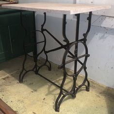 a table that is sitting in the middle of a room next to a green cabinet