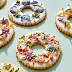 there are many cookies decorated with flowers on the cookie sheet and frosted in icing