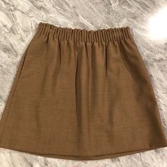 Brand New With Tags. Camel Colored Wool Blend Skirt. Chic Beige Mini Skirt With Elastic Waistband, Brown Relaxed Fit Skirt For Day Out, Casual Mini Skirt With Elastic Waistband For Work, Relaxed Brown Skirt For Day Out, Casual Brown Mini Skirt For Work, Chic Brown Skirted Skort, Tartan Mini Skirt, White Floral Skirt, Silver Skirt