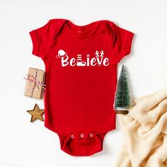 The perfect bodysuit for your perfect baby! These short sleeve bodysuits have 3 snap closure and double needle ribbed binding on neck, shoulders, sleeves, and leg openings. Machine wash cold, inside out. Air dry or tumble dry low. Baby Onesie Ideas, Onesie Ideas, My 1st Christmas, Believe Christmas, Christmas Onesie, Gerber Baby, Holiday Baby