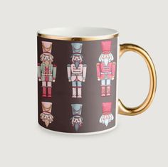 a coffee mug with an image of nutcrackers in different colors and sizes