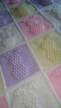 a crocheted blanket that has squares on it