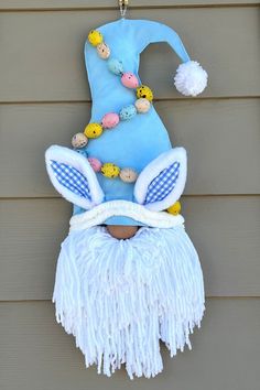 a blue and white decoration hanging on the side of a house