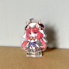 a plastic keychain with an anime character on it