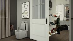 a white toilet sitting in a bathroom next to a walk in closet with shoes on the floor