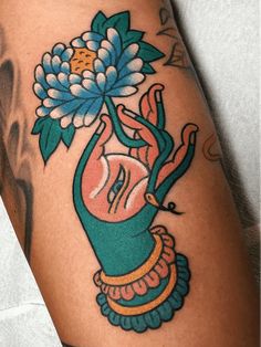 a close up of a person's leg with a flower on it and an elephant