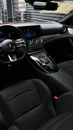 the interior of a car with black leather seats and steering wheel, dash lights, and dashboard controls