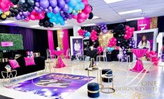 a room filled with lots of balloons and tables covered in pink, purple and gold decorations