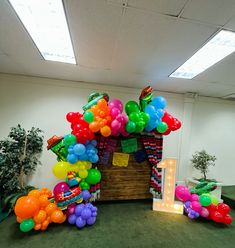 an office decorated with balloons and streamers in the shape of a house for a birthday party