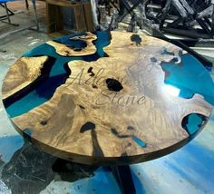 a wooden table with blue and black paint on it