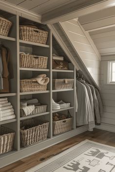 an attic closet with baskets, towels and blankets on shelves next to a rug in the floor