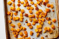 roasted sweet potatoes on a baking sheet ready to go into the oven